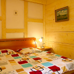 Sypialnia wykończona jasnym drewnem